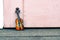 Music passion and hobby concept, violin miniature over wooden wall with retro color tone