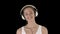 Music, people and technology concept - happy smiling woman with headphones walking, Alpha Channel