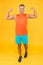 Music is power. Happy man fix arms yellow background. Fit guy show muscle power. Gym clothes and sportwear. Power and