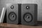 Music speakers on the bookshelf. Professional wooden bookshelf speaker has a classic, elegant look. 3D rendering