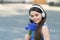 Music to your ears. Happy baby with flowers listen to music. Little girl wear headphones playing music. Summer vacation