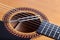 Music tuning fork on acoustic guitar strings