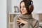 music woman student caucasian sofa home headphones happy earphones indoor young