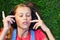 Musical cheerful mood. A young girl lies on the grass and listens to music on headphones