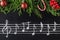Musical christmas background with fir branches and red festive decoration ball