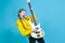 Musical Concepts. One Winsome Caucasian Female Guitar Player With White Bass Guitar Holding Instrument Nearby With Positive