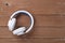 Musical equipment - White wireless headphone on a wooden background