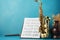 Musical harmony: Golden saxophones and a notebook on a captivating blue background.