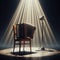 A musical instrument: accordion, sits on alone on stage ready to play, under a strong single spotlight