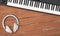 Musical instrument - Fragment Black MIDI keyboard, wireless headphone wood background