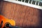 Musical instrument - MIDI keyboard and acoustic guitar wood background