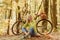 Musical pause. Blonde enjoy relax forest. Warm autumn. Girl with bicycle and headphones. Woman with bicycle autumn