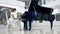 Musical pianist playing classical grand piano in a center of concert hall. Steadycam shot.