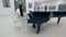 Musical pianist playing classical grand piano in a center of concert hall. Steadycam shot.