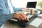 Musical producer working on his workplace on gray textured table