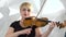 Musical quartet girls performs the composition on three violins and cello. White studio. Close up