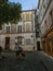 Musician carries acoustic bass up cobbled street on Montmartre in Paris, France