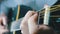 Musician clamps the chords on the acoustic guitar frets. Slow motion