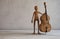 Musician with a double bass in a white studio room.