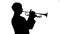 Musician fast playing trumpet in a studio. Silhouette