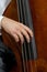 Musician hand playing the contrabass