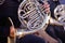 Musician horn player performs his musical part in a symphony orchestra. Unrecognizable, close-up, part of body and hands. Brass