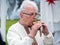 Musician man plying gemshorn ethnic musical instrument ocarina family made of horn. Ukraininan folk music festival Lviv