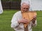 Musician man plying sopilka rebro ethnic woodwind musical instrument. Pan flute music festival Lviv, Ukraine May 14 2022