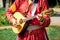 Musician in medieval bright clothes plays on lute. Festival of Medieval Music and Culture