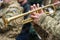 Musician military band of the Ukrainian army plays the trumpet on the march,