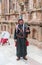 A musician in national clothes plays the bagpipe and poses with a tourist in Southern Theatre in ruins of Roman city Jerash - Gera