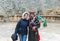 A musician in national clothes plays the bagpipe and poses with a tourist in Southern Theatre in ruins of Roman city Jerash - Gera