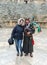 A musician in national clothes plays the bagpipe and poses with a tourist in Southern Theatre in ruins of Roman city Jerash - Gera