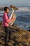 Musician play to musical instrument Tuba on romantic sea shore. Hobby.