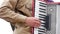 Musician playing the accordion. Hand playing accordions closeup. Accordion player.