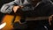 Musician playing acoustic guitar closeup, enjoying live session on performance