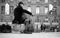 Musician playing with cello on a cobbles place in front of the cathedral