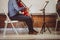 Musician playing cello with musical notes on the book notation stand in front of him