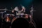 Musician playing drums, black background and beautiful soft light