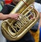 Musician is playing on the tuba.