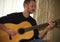 A Musician Plays a Classical Acoustic Guitar