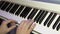 The musician plays on a digital piano. Hands of the pianist. A synthesizer or electronic piano