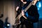 The musician plays the electric guitar on stage. Guitar neck close-up on a concert of rock music in the hands of a musician.