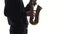 Musician plays an old saxophone. Closeup on white background