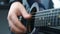 Musician Plays Strings With His Fingers On An Guitar.