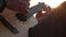 A musician plays on the ukulele close-up of his hands and the fretboard of a guitar.