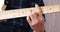 Musician practicing electric guitar, close-up, focus on right hand