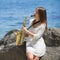 Musician on rocky seashore