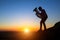 Musician silhouette play Tuba on sea shore at sunset. Concert.