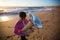 Musician with a tuba playing on the sea beach. Jazz.